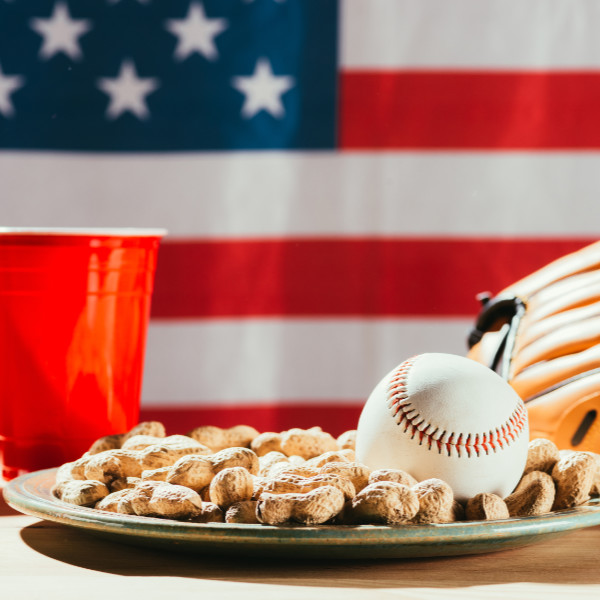 close-up view of baseball ball on plate with peanuts, red plasti